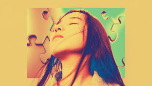 A long haired person with closed eyes appears against a puzzle piece background